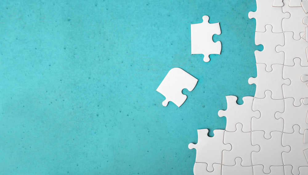 many-white-piece-puzzle-blue-background